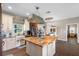 Open kitchen with a large island and pendant lighting at 8602 State Road 674, Wimauma, FL 33598
