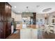 Large kitchen with an island, farmhouse sink, and stainless steel appliances at 8602 State Road 674, Wimauma, FL 33598