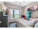 Cozy bedroom with a rustic dresser and view of the backyard at 8602 State Road 674, Wimauma, FL 33598