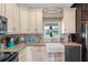 Farmhouse kitchen with white cabinets and subway tile backsplash at 8602 State Road 674, Wimauma, FL 33598
