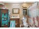 Rustic bathroom with wooden vanity and shower at 8602 State Road 674, Wimauma, FL 33598