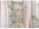 Walk-in shower with tile surround and pink curtains at 8602 State Road 674, Wimauma, FL 33598
