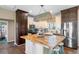 Farmhouse-style kitchen with butcher block island and dark cabinets at 8602 State Road 674, Wimauma, FL 33598