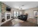 Relaxing living room with a fireplace and leather couches at 8602 State Road 674, Wimauma, FL 33598