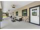 Covered patio with seating area and access to backyard at 8602 State Road 674, Wimauma, FL 33598