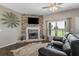 Living area featuring a stone fireplace and comfortable seating at 8602 State Road 674, Wimauma, FL 33598