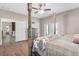 Spacious bedroom with a post bed, hardwood floors, and access to the kitchen at 8602 State Road 674, Wimauma, FL 33598