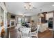Open concept dining area with stone fireplace and chandelier at 8602 State Road 674, Wimauma, FL 33598
