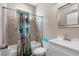 Bright bathroom with a floral shower curtain and white vanity at 8602 State Road 674, Wimauma, FL 33598