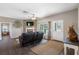 Spacious living room with fireplace and large windows offering natural light at 8602 State Road 674, Wimauma, FL 33598