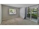 Bright bedroom with neutral walls, carpet flooring, and sliding glass doors at 11812 Raintree Lake Ln # B, Tampa, FL 33617