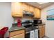 Bright kitchen with stainless steel appliances and wood cabinets at 400 64Th Ave # 704, St Pete Beach, FL 33706