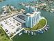 Aerial view of waterfront condo building with parking and boat slips at 400 64Th Ave # 704, St Pete Beach, FL 33706