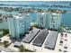 Aerial view of waterfront property with two towers, parking, and boat slips at 400 64Th Ave # 704, St Pete Beach, FL 33706