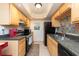 Well-equipped kitchen with wood cabinets and tile backsplash at 400 64Th Ave # 704, St Pete Beach, FL 33706