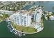 Aerial view of waterfront property with two towers, pool and boat slips at 400 64Th Ave # 704, St Pete Beach, FL 33706