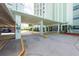 Condo building entrance with covered parking and security features at 400 64Th Ave # 704, St Pete Beach, FL 33706