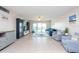 Living room with tiled floors, comfy seating, and water views at 400 64Th Ave # 704, St Pete Beach, FL 33706