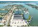 Aerial view of waterfront property with two towers, parking and boat slips at 400 64Th Ave # 704, St Pete Beach, FL 33706