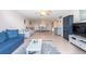Bright living room with comfy seating and a large TV at 400 64Th Ave # 704, St Pete Beach, FL 33706