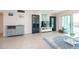 Living room with tiled floors, comfy seating, and water views at 400 64Th Ave # 704, St Pete Beach, FL 33706