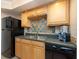 Efficient kitchen with black appliances and colorful tile at 400 64Th Ave # 704, St Pete Beach, FL 33706