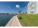 A paved waterfront walkway with a bench offers scenic views at 400 64Th Ave # 704, St Pete Beach, FL 33706
