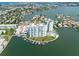 Aerial view of waterfront property with two towers and boat slips at 400 64Th Ave # 704, St Pete Beach, FL 33706