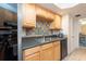 Kitchen with double sink, wood cabinets, and tile backsplash at 400 64Th Ave # 704, St Pete Beach, FL 33706