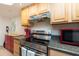Updated kitchen featuring stainless steel appliances and wood cabinetry at 400 64Th Ave # 704, St Pete Beach, FL 33706