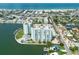 Aerial view of waterfront property with two towers, pool, and parking at 400 64Th Ave # 704, St Pete Beach, FL 33706