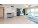 Living room with tiled floors, comfy seating, and water views at 400 64Th Ave # 704, St Pete Beach, FL 33706