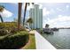 Building exterior showcasing waterfront location and landscaping at 400 64Th Ave # 704, St Pete Beach, FL 33706