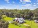 Stunning aerial view of a custom home on a lush, expansive lot with mature trees and plenty of green space at 3520 Leslie West Rd, Dover, FL 33527