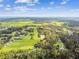 Scenic aerial view showcasing extensive land with scattered homes, lush greenery, and winding roads under a clear sky at 3520 Leslie West Rd, Dover, FL 33527
