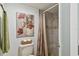 Tiled bathroom featuring a shower, toilet with decor, and a linen green towel rack at 3520 Leslie West Rd, Dover, FL 33527