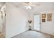 Bright bedroom features neutral carpet, white walls, and a door to the outside at 3520 Leslie West Rd, Dover, FL 33527