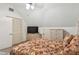 Upstairs bedroom with wicker furniture and TV at 3520 Leslie West Rd, Dover, FL 33527