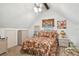 Upstairs bedroom with angled ceiling and floral bedding at 3520 Leslie West Rd, Dover, FL 33527