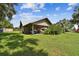 Attached carport with ample space for vehicles and storage, blending with the surrounding green landscape at 3520 Leslie West Rd, Dover, FL 33527