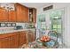 Kitchen breakfast nook with a glass top table, wicker chairs and granite countertops at 3520 Leslie West Rd, Dover, FL 33527