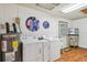 Functional laundry room with washer, dryer, water heater, and plenty of space for folding laundry at 3520 Leslie West Rd, Dover, FL 33527