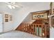 Loft with wooden railings overlooking the living room, providing an open and airy feel at 3520 Leslie West Rd, Dover, FL 33527
