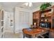 View of the office including a large desk, storage and passage to another room at 3520 Leslie West Rd, Dover, FL 33527