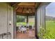 Screened porch has wood floors and a relaxing sitting area at 3520 Leslie West Rd, Dover, FL 33527