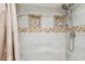 Shower design featuring grey tiling, a rain shower head, and custom-built shower caddies at 3520 Leslie West Rd, Dover, FL 33527