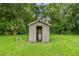 Small wooden well house surrounded by green grass and lush trees, providing a functional water system at 3520 Leslie West Rd, Dover, FL 33527