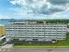Aerial view of a multi-level building near the water at 100 Bluff View Dr # 404A, Belleair Bluffs, FL 33770