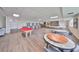 Community room with pool table, tables and chairs, and bookcases at 100 Bluff View Dr # 404A, Belleair Bluffs, FL 33770