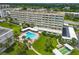 Aerial view showcasing building, pool, and landscaping at 100 Bluff View Dr # 404A, Belleair Bluffs, FL 33770
